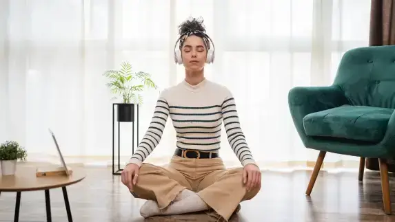mulher-com-fono-de-ouvido-praticando-a-meditação-mindfulness-guiada-